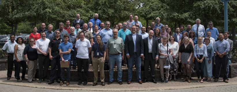 New Jersey Geospatial Forum employees standing and position outside for a picture